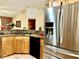 Functional kitchen with stainless steel refrigerator and granite countertops at 6704 Westlake Blvd, Orlando, FL 32810
