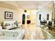 Bright living room with white furniture, tile floors, ceiling fan, and unique decor features at 6704 Westlake Blvd, Orlando, FL 32810