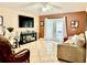 Cozy living room with tile floors, comfortable furniture and a view to the patio at 6704 Westlake Blvd, Orlando, FL 32810
