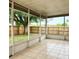 Enclosed patio with tile flooring overlooks a fenced yard with a mature tree at 6704 Westlake Blvd, Orlando, FL 32810