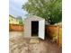 Backyard view of a storage shed with an open door next to a wooden fence at 6704 Westlake Blvd, Orlando, FL 32810