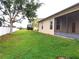 This backyard features a green lawn and views of neighboring homes at 6728 Duncaster St, Windermere, FL 34786