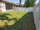 Large, fenced backyard with lush green grass, offering privacy and space for outdoor activities at 6728 Duncaster St, Windermere, FL 34786