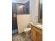 Modern bathroom featuring a tiled shower and vanity with granite countertop at 6728 Duncaster St, Windermere, FL 34786