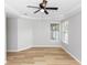 The bedroom has neutral paint, wood floors, and windows for natural light at 6728 Duncaster St, Windermere, FL 34786