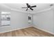 The bedroom offers a modern ceiling fan and two windows overlooking the neighborhood at 6728 Duncaster St, Windermere, FL 34786