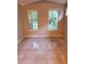 This bedroom features two windows and tile flooring at 6728 Duncaster St, Windermere, FL 34786