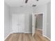 Bedroom with plank flooring, ceiling fan, and ensuite bath at 6728 Duncaster St, Windermere, FL 34786