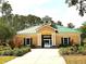 Clubhouse with green roof, beige siding, and professional landscaping at 6728 Duncaster St, Windermere, FL 34786
