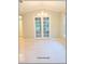 Bright dining room boasts white tile floors, a chandelier and french doors to an office at 6728 Duncaster St, Windermere, FL 34786