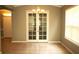 Bright dining room with large window and french doors leading to office or den at 6728 Duncaster St, Windermere, FL 34786