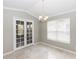 Bright dining room features elegant French doors and tile flooring, perfect for gatherings at 6728 Duncaster St, Windermere, FL 34786