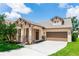 Charming single-Gathering home featuring a two-car garage, stone accents, and a well-manicured lawn at 6728 Duncaster St, Windermere, FL 34786