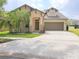 Charming single-Gathering home featuring a two-car garage, manicured lawn, and welcoming front porch at 6728 Duncaster St, Windermere, FL 34786