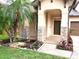 Inviting front porch featuring stacked stone accents, lush landscaping and a welcoming entrance at 6728 Duncaster St, Windermere, FL 34786
