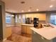 Spacious kitchen featuring stainless steel appliances, a breakfast bar and ample counter space at 6728 Duncaster St, Windermere, FL 34786