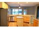 Modern kitchen with stainless appliances, light-colored wood cabinets, island, and tile flooring at 6728 Duncaster St, Windermere, FL 34786