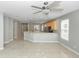 An open concept living and kitchen area with tile floors and ceiling fan at 6728 Duncaster St, Windermere, FL 34786