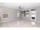 A bright living room with tiled floors and a large window providing ample natural light at 6728 Duncaster St, Windermere, FL 34786