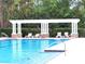 Community pool with tanning chairs and a trellis at 6728 Duncaster St, Windermere, FL 34786