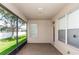 View of a covered, screened in patio with a view to the green lawn and backyard at 6728 Duncaster St, Windermere, FL 34786
