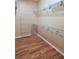 Walk-in closet with laminate floors, multiple shelves and lots of storage space at 6728 Duncaster St, Windermere, FL 34786