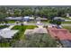 Aerial view of the home showcasing a tidy street with mature trees and well-kept lawns at 721 Fairway Dr, New Smyrna Beach, FL 32168