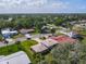 Aerial view of a home in a peaceful neighborhood with mature trees and well-maintained yards at 721 Fairway Dr, New Smyrna Beach, FL 32168