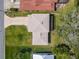Aerial view of a well-maintained single-Gathering home with a gray roof and a large green yard at 721 Fairway Dr, New Smyrna Beach, FL 32168