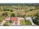 An aerial view of property with a golf course in the background at 721 Fairway Dr, New Smyrna Beach, FL 32168