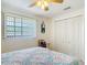 Bedroom featuring comfortable bedding, natural light, and neutral wall color at 721 Fairway Dr, New Smyrna Beach, FL 32168
