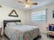 Bedroom featuring stylish bedding, natural light from window, and charming decor at 721 Fairway Dr, New Smyrna Beach, FL 32168