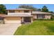 Charming two-story home with stone accents, well-manicured lawn, and inviting front entrance at 721 Fairway Dr, New Smyrna Beach, FL 32168