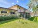 Exterior view of the home showcasing the stone accents, upper deck and a well-maintained lawn and garden at 721 Fairway Dr, New Smyrna Beach, FL 32168