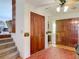 Inviting foyer featuring a wood closet, decorative accents, and seamlessly flowing tile flooring at 721 Fairway Dr, New Smyrna Beach, FL 32168