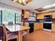 Charming eat-in kitchen with ample cabinet space and vintage wallpaper at 721 Fairway Dr, New Smyrna Beach, FL 32168