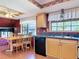 Traditional eat-in kitchen featuring wood cabinets, dual stainless steel sink, and a matching wood dining set at 721 Fairway Dr, New Smyrna Beach, FL 32168