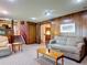 Spacious living room with wood paneling and neutral carpeting at 721 Fairway Dr, New Smyrna Beach, FL 32168