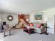 Inviting living room featuring plush carpet, wood accents, and ample seating at 721 Fairway Dr, New Smyrna Beach, FL 32168
