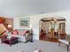Comfortable living room with neutral tones, decorative accents, and an archway leading to the dining area at 721 Fairway Dr, New Smyrna Beach, FL 32168