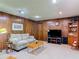 Comfortable living room with wood-paneled walls and a cozy atmosphere at 721 Fairway Dr, New Smyrna Beach, FL 32168