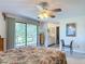 A light and airy main bedroom with patio access and adjacent bathroom at 721 Fairway Dr, New Smyrna Beach, FL 32168