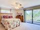 Cozy bedroom featuring a ceiling fan and patio access at 721 Fairway Dr, New Smyrna Beach, FL 32168