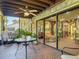 Cozy screened patio featuring comfortable seating and seamless transition to the living room through sliding glass doors at 721 Fairway Dr, New Smyrna Beach, FL 32168