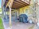 Charming patio with stone accents and grill, ideal for outdoor cooking and entertaining at 721 Fairway Dr, New Smyrna Beach, FL 32168
