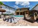 This home's backyard includes a pool, oversized chess, outdoor daybed, and a tiki bar, perfect for entertaining at 8180 Valhalla Ter, Reunion, FL 34747