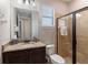 Clean bathroom featuring a glass shower, granite countertop, and a modern vanity at 8180 Valhalla Ter, Reunion, FL 34747