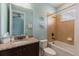 Bright bathroom featuring granite vanity, decorative starfish and a shower-tub combination at 8180 Valhalla Ter, Reunion, FL 34747