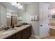 Elegant bathroom featuring double sinks, granite countertops, and a large mirror above the vanity at 8180 Valhalla Ter, Reunion, FL 34747
