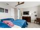 Comfortable bedroom featuring twin beds with unique fan, and TV with chest of drawers below at 8180 Valhalla Ter, Reunion, FL 34747